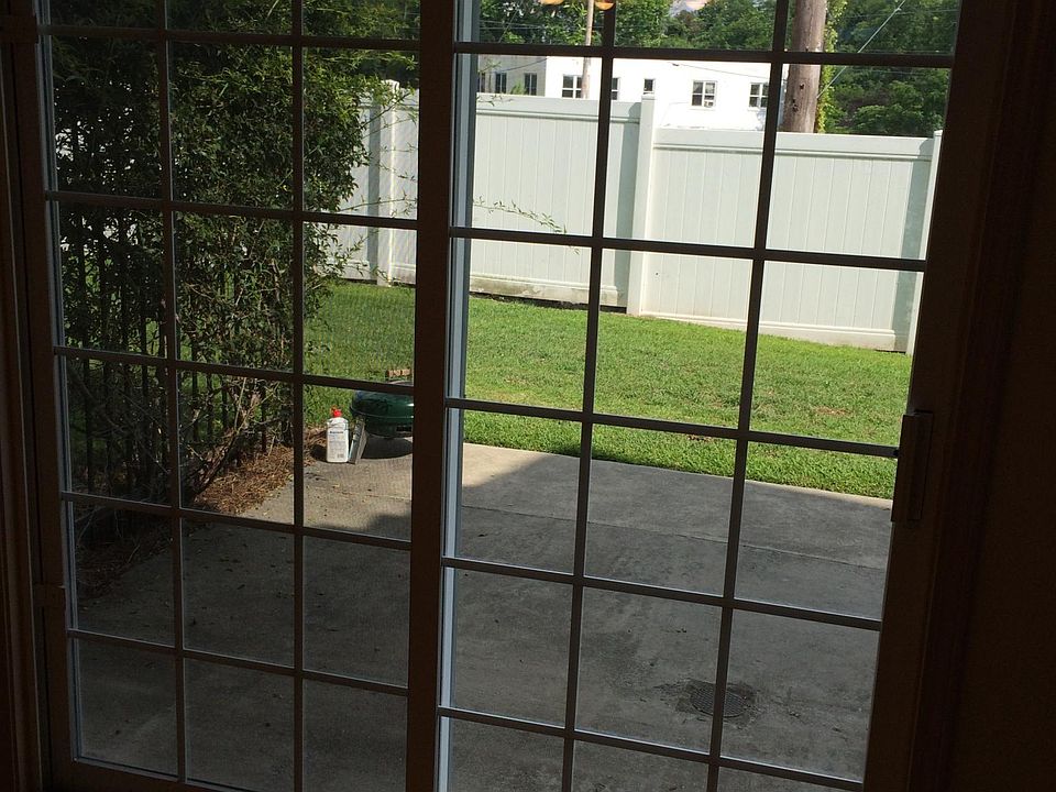 Sliding door off the breakfast/dining room to back concrete patio and grass yard with privacy fencing at property line.