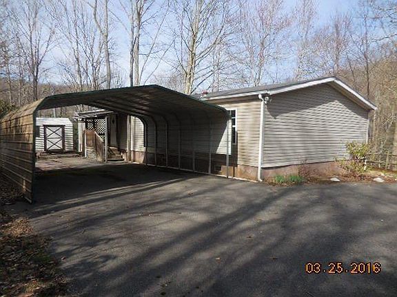 Back of the house with covered double carport. Shed in the back