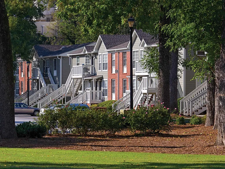 Lush landscaping and tall trees surround our apartment homes