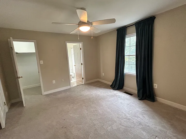 Front-facing bedroom on second floor with fan, walk-in closet and attached full bath. A spacious room! Carpet is two years old