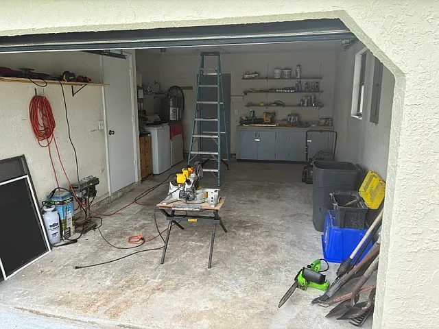 Garage with workbench, washer, and dryer