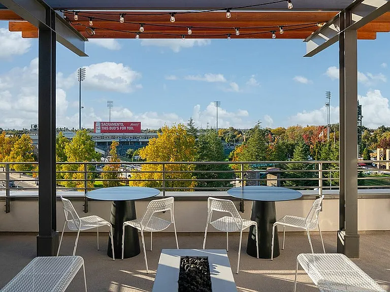 Experience urban elegance with stunning views from this chic rooftop terrace at 805 Riverfront Apartments in Sacramento