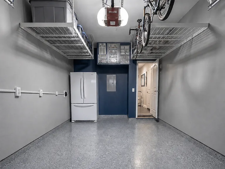 Garage has finished floor and electrical outlets. Refrigerator is not included. Charging for electric car available.