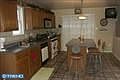 Kitchen, tiled floor, sliders to covered deck