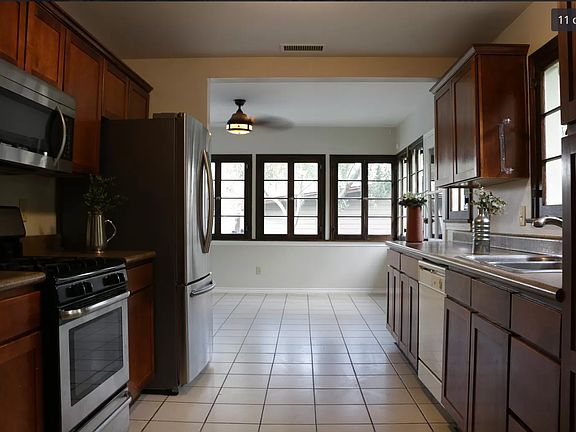 Nice shot of the family room through the kitchen and some of the many french windows-- the scale and proportions of the home combine to create a welcoming, calm space