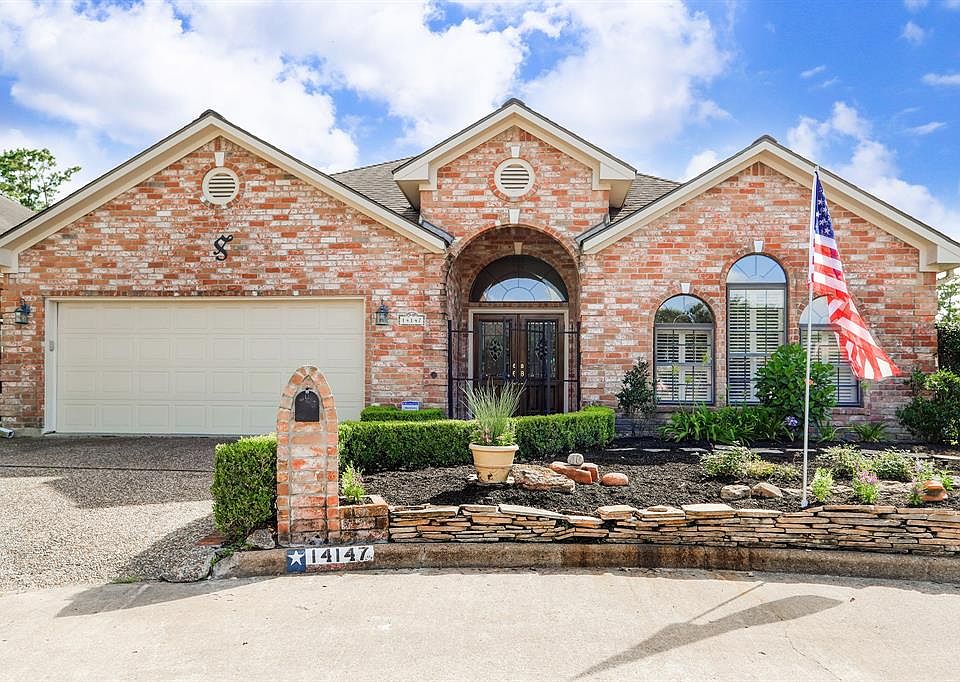 Lovely Brick Home with Stacked Stone Wall and Landscaping