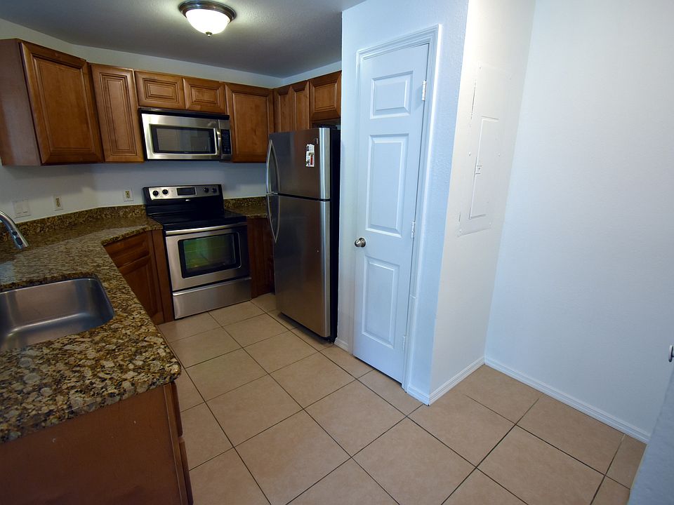 The kitchen features stainless steal appliances, a granite countertop, and a pantry.