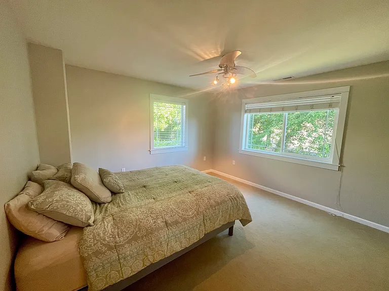 Your bedroom with ceiling fan, large windows and blinds