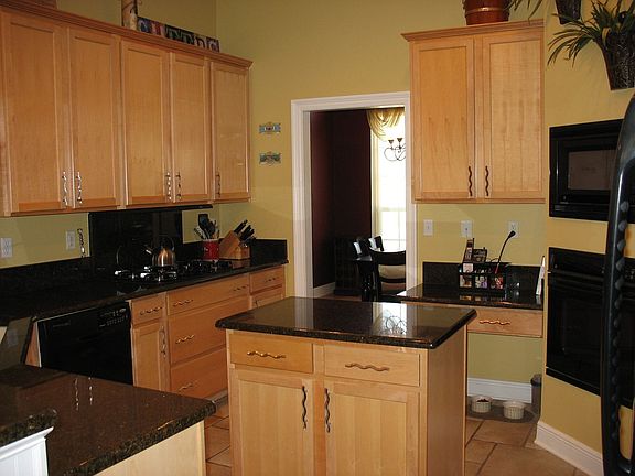 Beautiful kitchen includes built-in appliances and granite countertops.