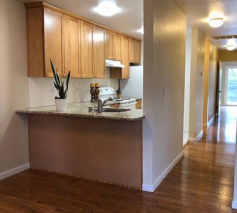 Counter height bar seating. Wood laminate flooring in all iiving areas, bedrooms.