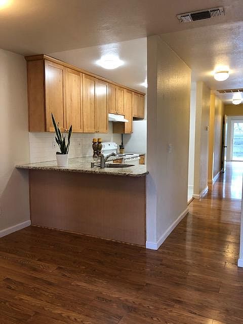 Counter height bar seating. Wood laminate flooring in all iiving areas, bedrooms.