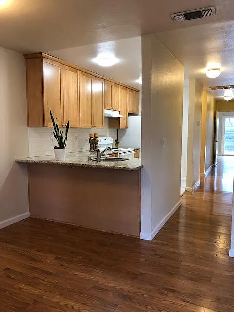 Counter height bar seating. Wood laminate flooring in all iiving areas, bedrooms.