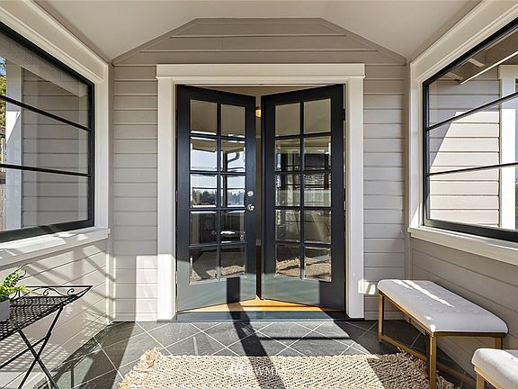 the welcoming front entry way offers a completely enclosed front porch which warmly greets guest, rain or shine!