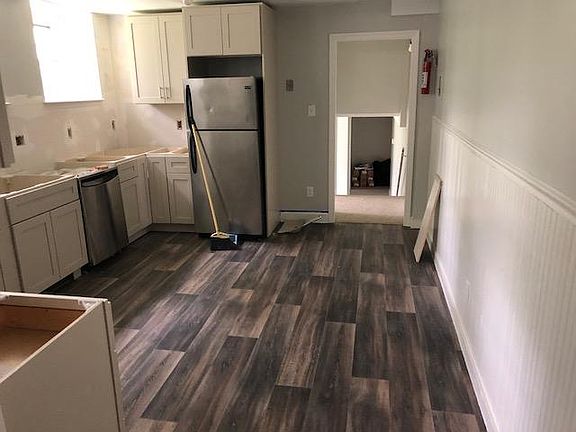 Kitchen with laminate flooring, new cabinets, hardware, quar