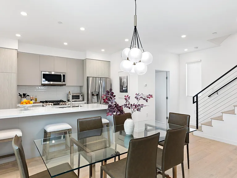 The formal dining space seats 6, with additional 4 counter stools.