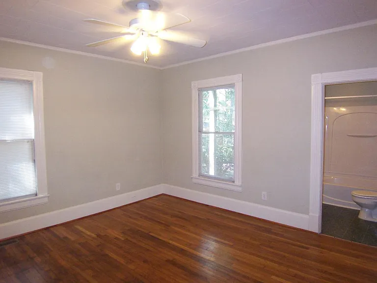 Bedroom with door to bathroom on right