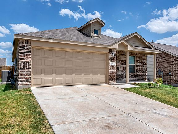 Ranch-style home featuring brick siding, concrete driveway, and a garage