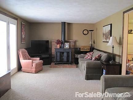 Living room
						:
						Includes a gas fireplace and entry to the stamped patio.