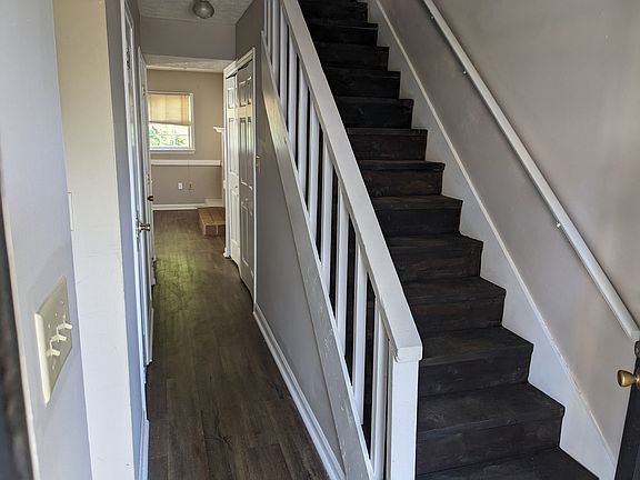 Entry way leading upstairs to the bedrooms w/private baths or go down the hall to the living room or turn right to go into the kitchen/dining area.
