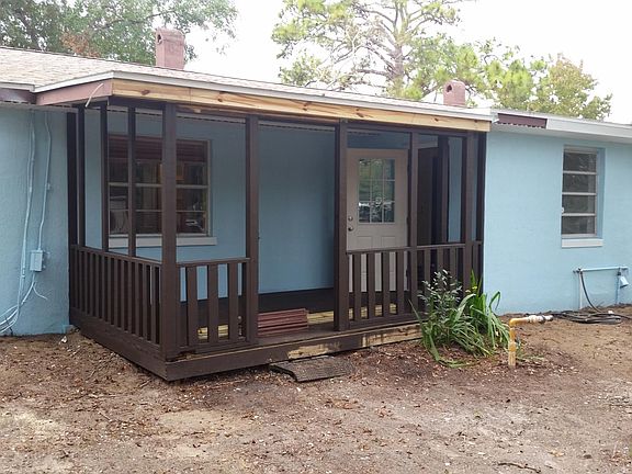 Screened in back porch overlooking a large private yard
