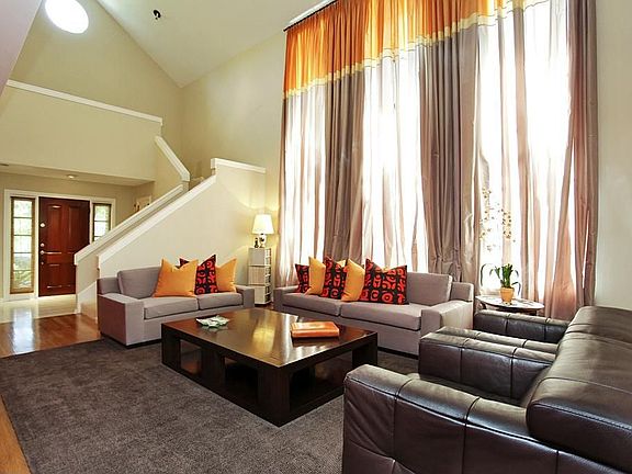 An impressive view of the living room looking towards the entry foyer.  Bright living area cheerfully welcomes any visitor.