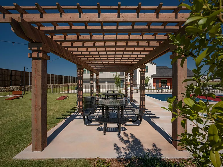 Game area outside with green trees and grass