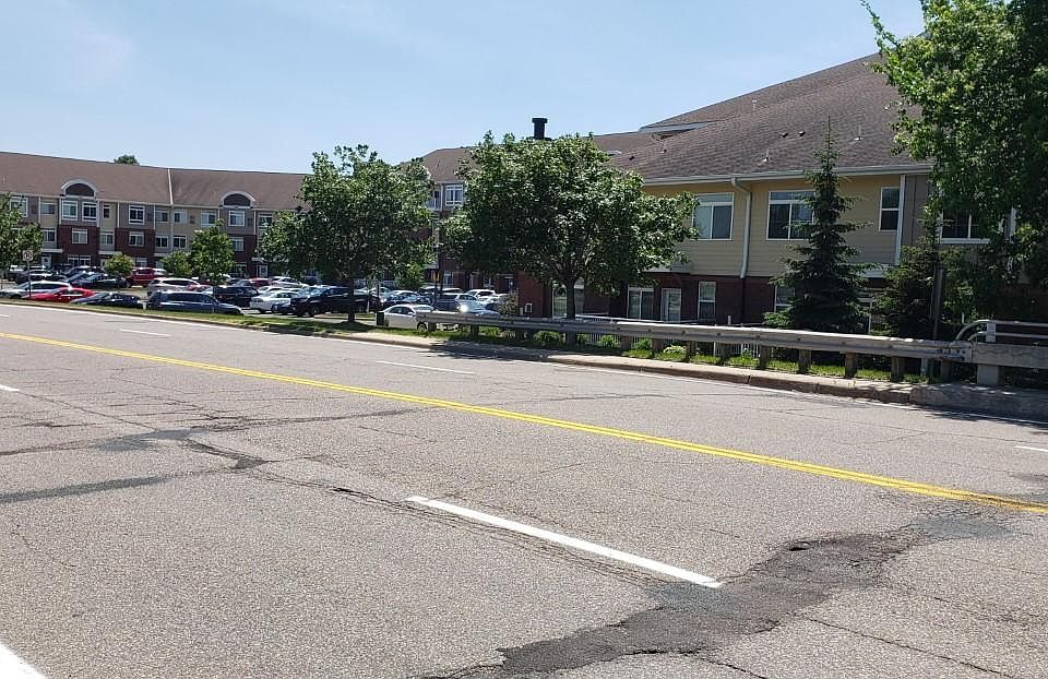 Cross street view shows sidewalk for convenient pedestrian travel to the shopping village