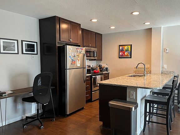 Kitchen. All tainless steel appliances. Huge granite counter.