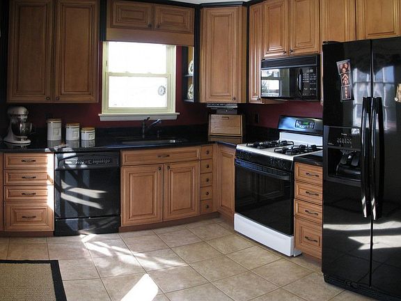Tall maple cabinets with pull-outs and pot rack.