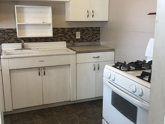 Gas stove and kitchen cabinetry. New LVT flooring since this picture was taken