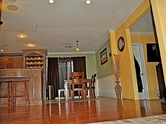 Hardwood and view of Dining with Beadboard Wainscotting