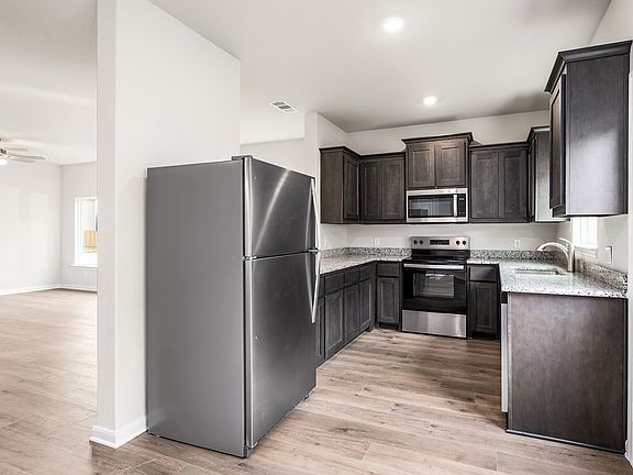 The kitchen has beautiful wood cabinetry.
