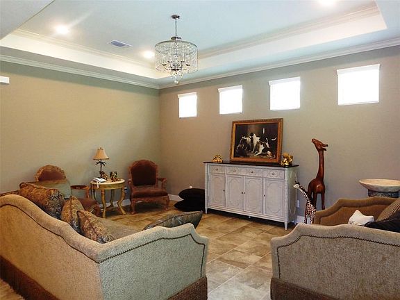 Who wouldn't want a large living area? A trayed ceiling, plenty of recessed lighting and lots of sunlight.