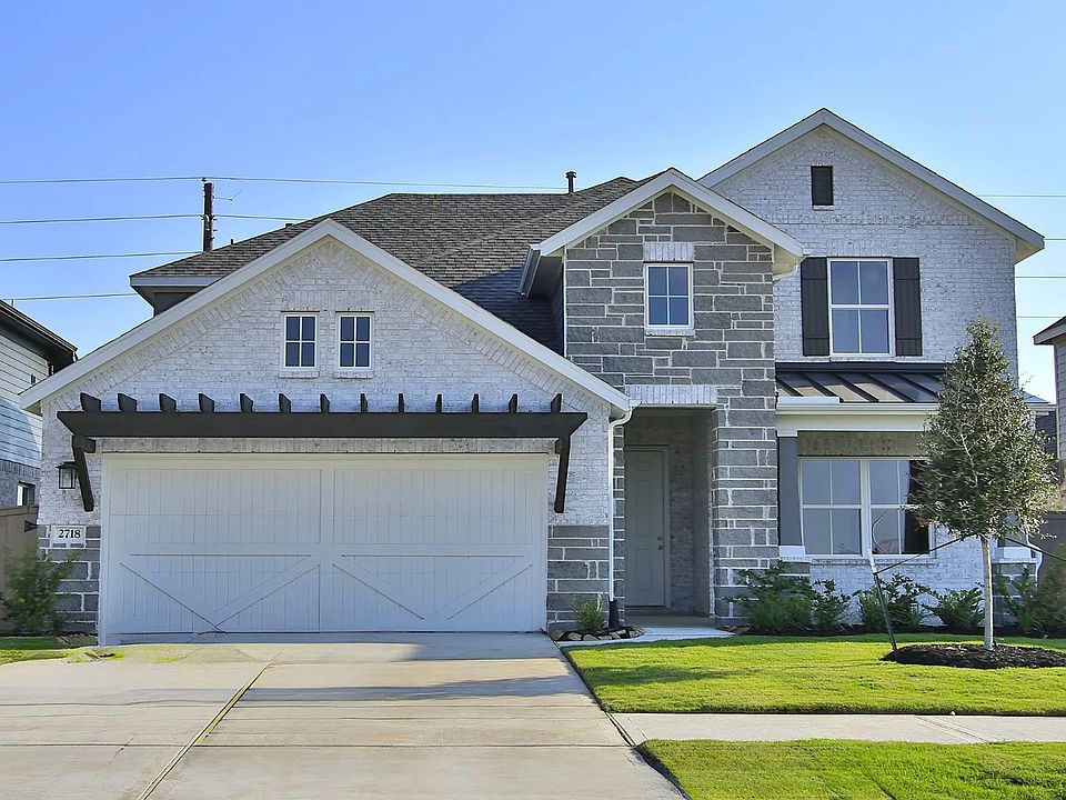 Luxurious stone facade, gable roof, elegant wooden shutters in Creekhaven community.