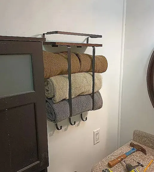 NICE RACK FOR YOUR TOWELS AND HUTCH BEHIND KOHLER TOILET AND GRANITE COUNTERTOP SINK