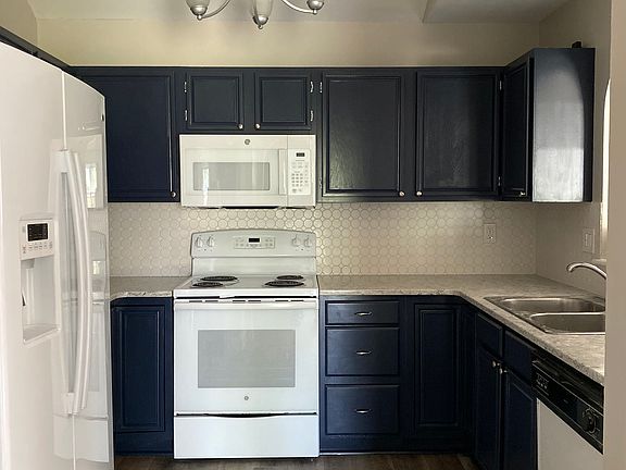 Painted kitchen cabinets with newer appliances (not shown: new dishwasher in 2023). Also has under cabinet lighting.