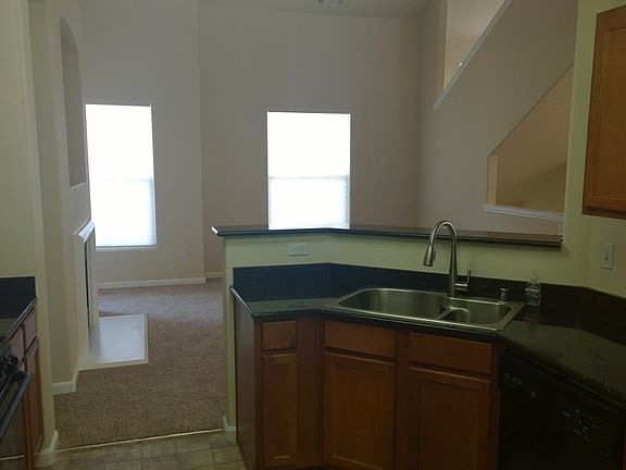 Kitchen opens to large living and dining areas