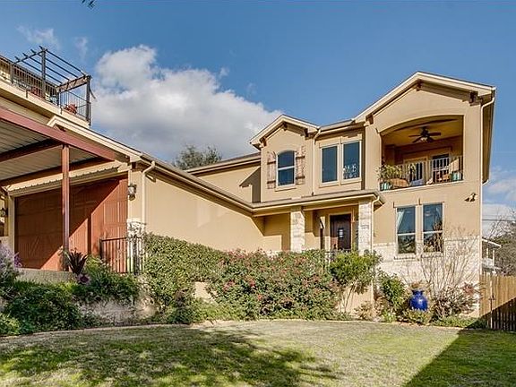 Landscaped yard and stone and stucco exterior