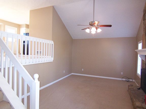 Great room with vaulted ceiling and fireplace