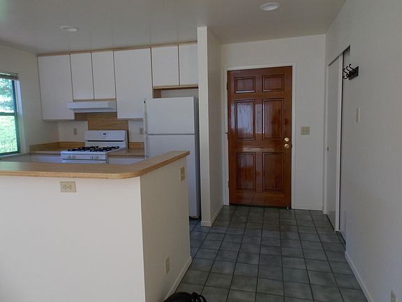Open concept kitchen with lots of cabinets.