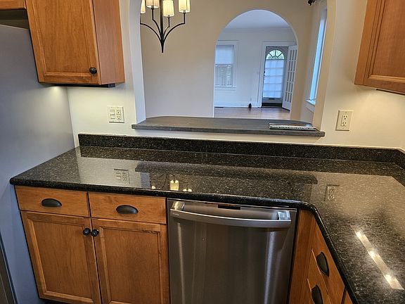 granite counter tops and stainless appliances looking toward the living room.