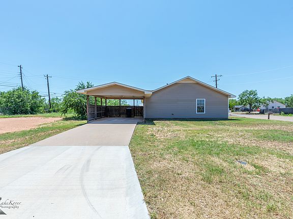 Spacious covered carport with a long driveway_plenty of room for parking! Quiet corner lot with a large yard and easy access from two streets.