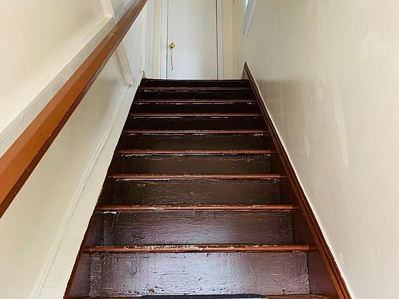 Stairs to the second floor. Apartment door to the left and additional closet door straight ahead.