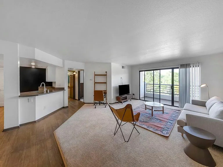 Furnished+ apartment homes come outfitted with a sofa, side chair, side table, coffee table, TV stand and 50" Television (Representative Image exact items and style of furnishings may vary)