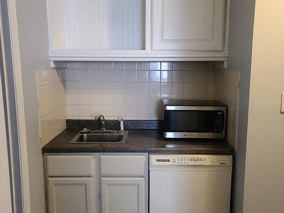 Across from Kitchenette is sink and dishwasher.