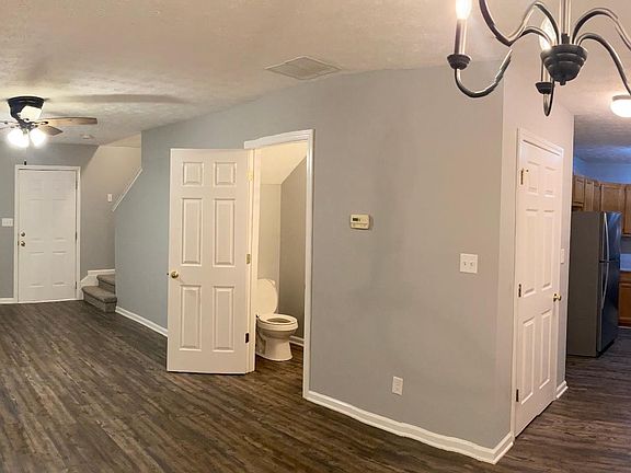 Looking from dining area kitchen on right with w/d hookups. 1/2 bath and front door.