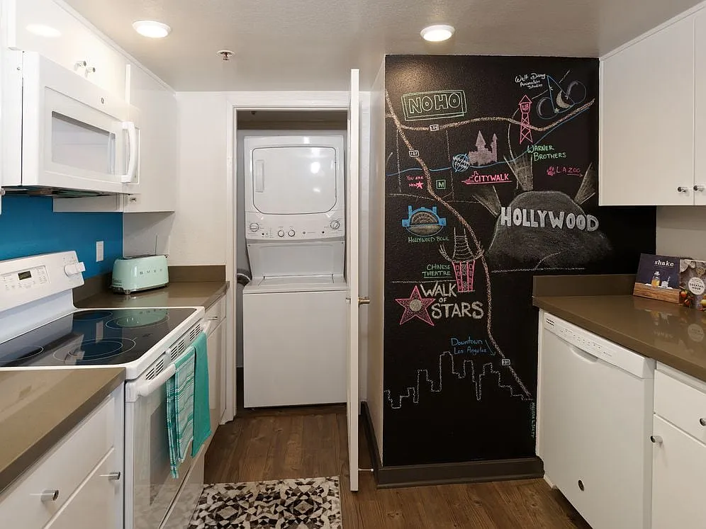 Standard Apartment Kitchen with Chalkboard Accent Wall and Washer Dryer - AVA Studio City