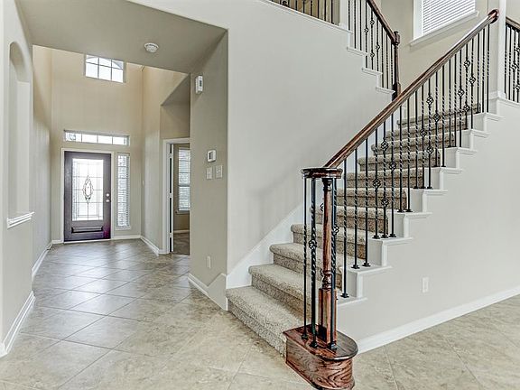 The wrought iron staircase is quite elegant and striking.