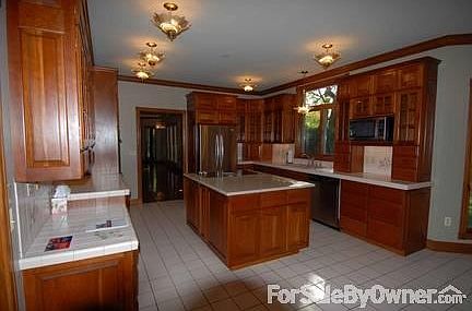 Kitchen
						:
						Kitchen with Custom Cherry Cabinets, Updated Stainless, Custom Painted Tile