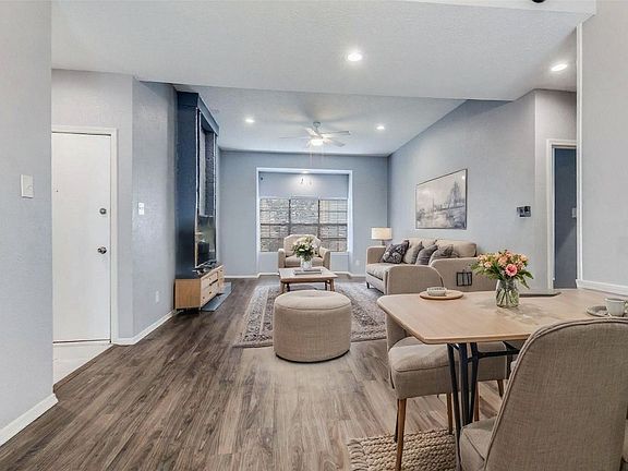 Living room and dining room shown with virtual AI staging.